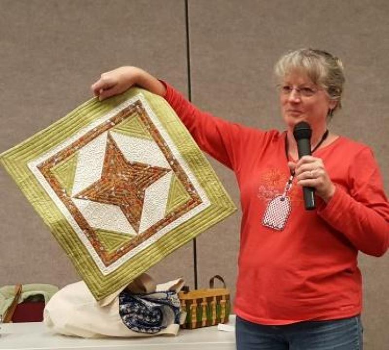 Carol shows a Friendship Star table topper she just made